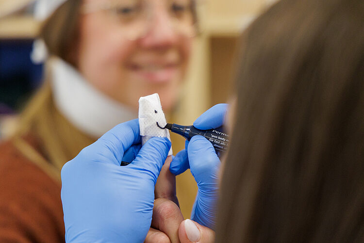 Teilnehmer üben Wundversorgung am Finger mit Pflaster im Erste Hilfe am Kind Kurs