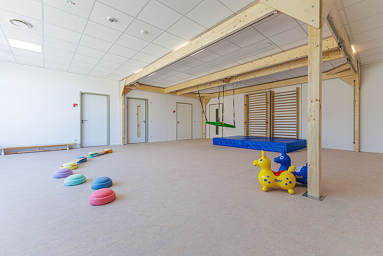 Bewegungsraum mit Hängeschaukel, Turnmatten, Balanciersteinen und Hüpfpferden