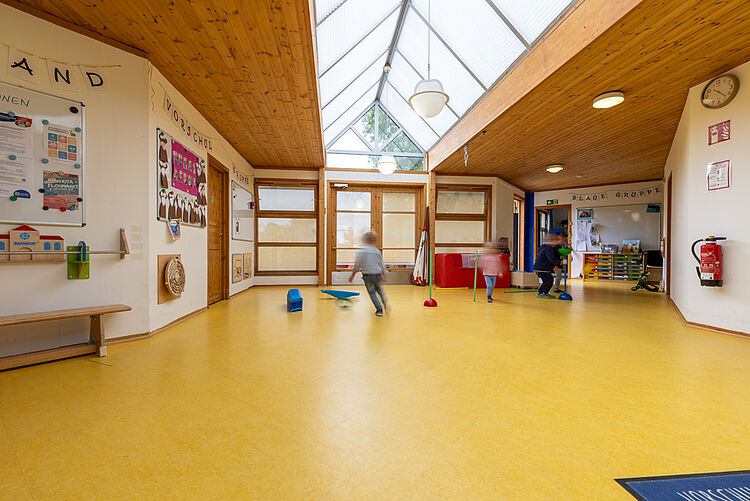 Kinder spielen im Bewegungsraum unter Oberlicht in der DRK-Kita Kunterbunt